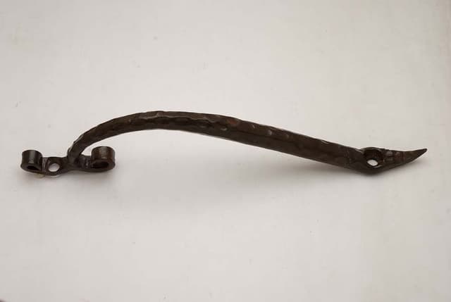 Ornate cast iron handle with decorative profile